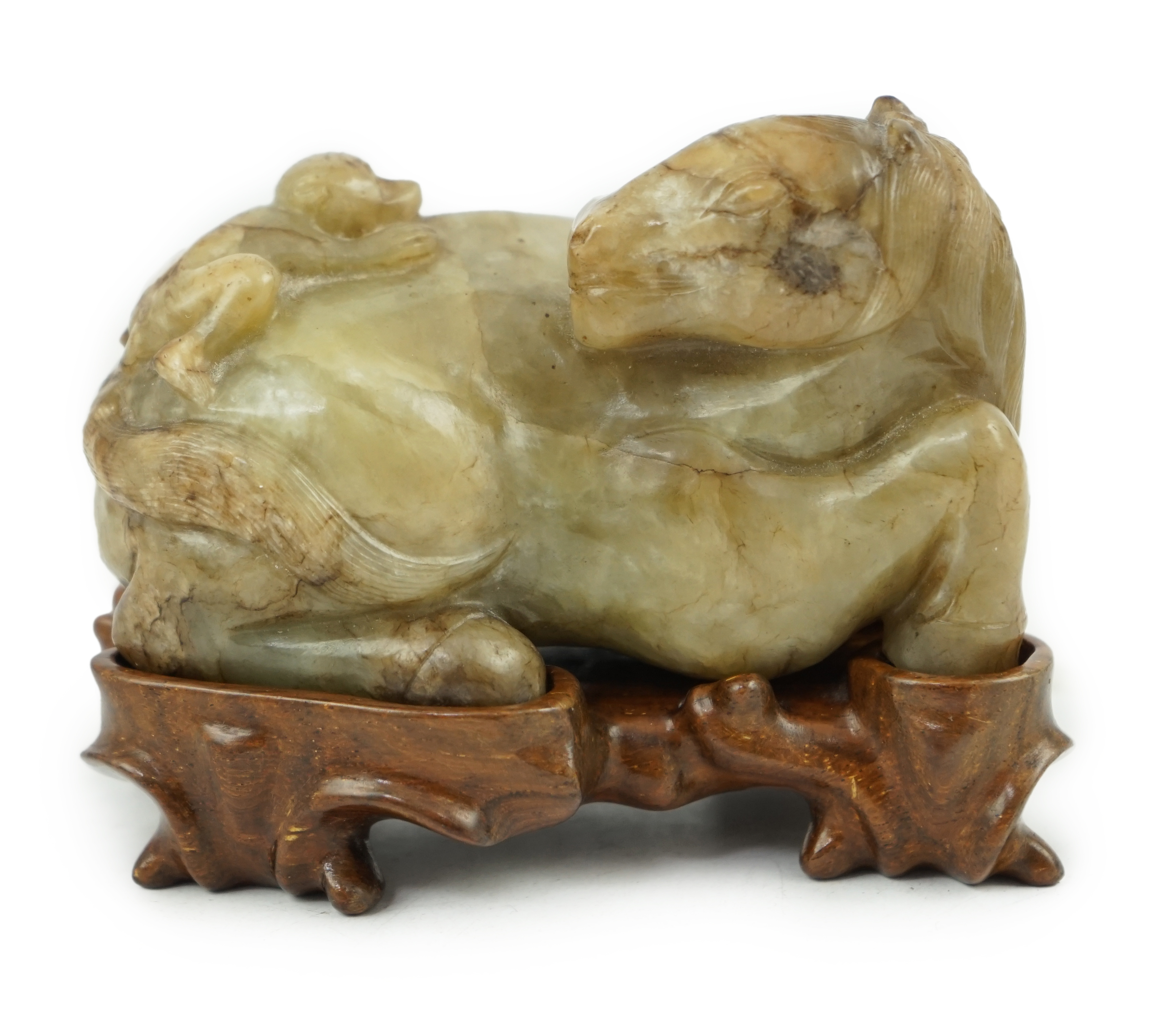 A Chinese celadon and mottled brown jade figure of a monkey climbing on a recumbent horse, Ming dynasty, 16th-17th century